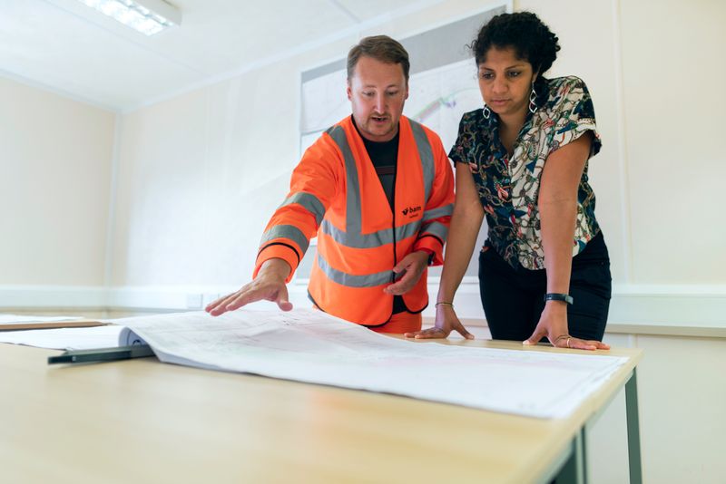 Engineers reviewing blueprints